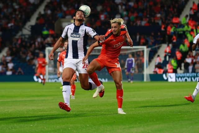 Harry Cornick battles for possession