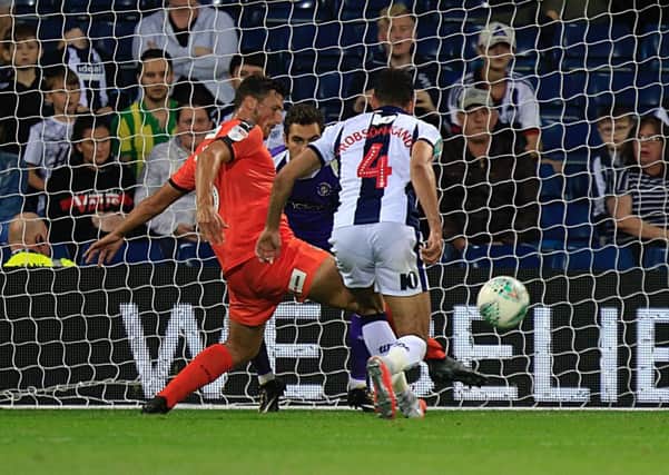Matty Pearson clears the danger against West Bromwich Albion