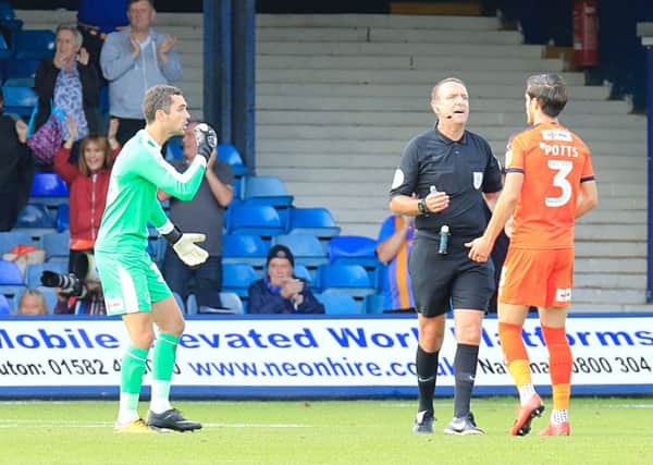 James Shea is convinced he has heard a whistle against Shrewsbury