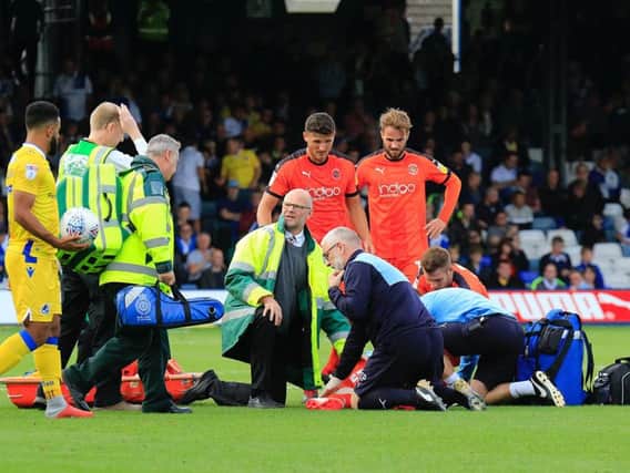 Eunan O'Kane is treated on the pitch against Bristol Rovers