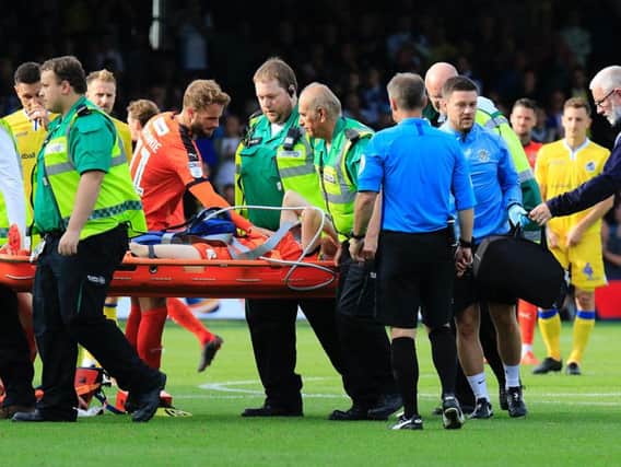Andrew Shinnie checks on Eunan O'Kane as he is stretchered off on Saturday