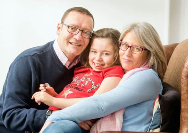 Lily Harriss with her parents Samantha and Simon. Photo by Adrian Sherratt