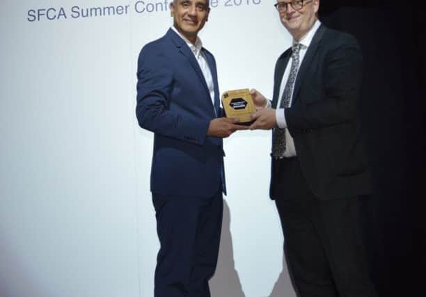 Luton Sixth Form College Principal Altaf Hussain being presented the award