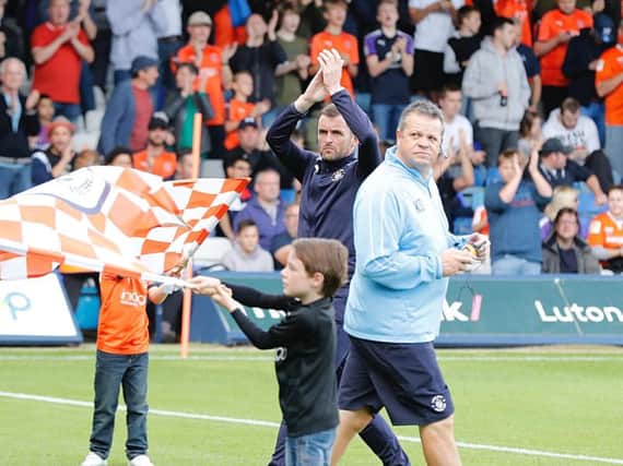 Hatters boss Nathan Jones applauds the fans at Kenilworth Road