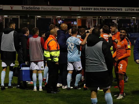Luton and Accrington players argue as they head off the pitch at half time on Tuesday night