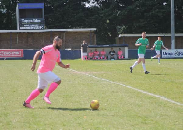 Daniel (left) in action at a charity match.
