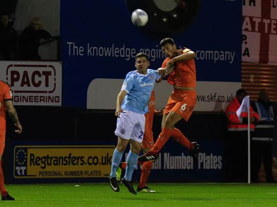 Matty Pearson heads away during Tuesday night's match with Accrington