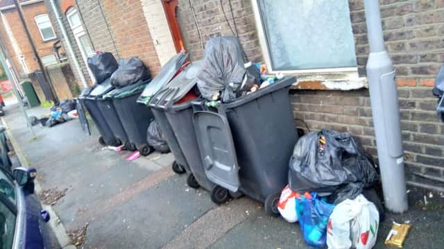 Excess bags of rubbish next to bins in Luton
