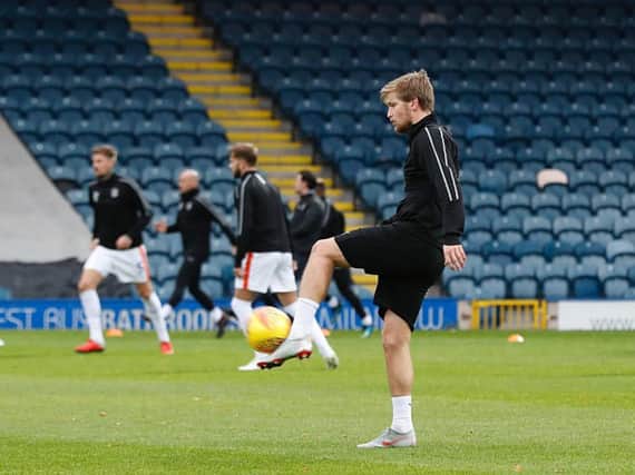 Luke Berry warms up with the first team recently