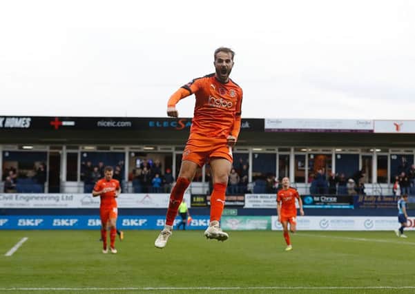 Taking to the air: Andrew Shinnie celebrates his goal against Wycombe