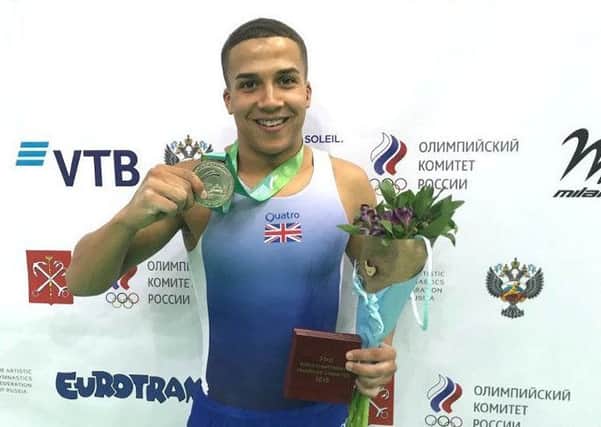 Elliot Browne celebrates with his silver medal - pic: British Gymnastics
