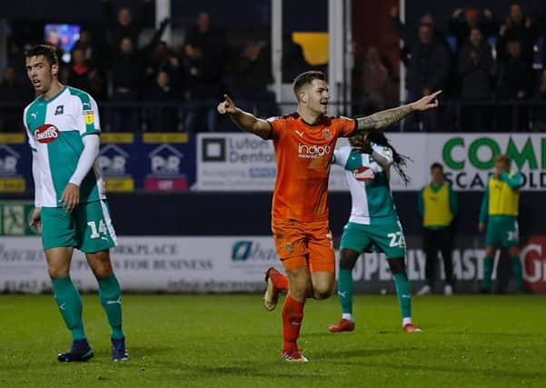 James Collins celebrates his hat-trick against Plymouth