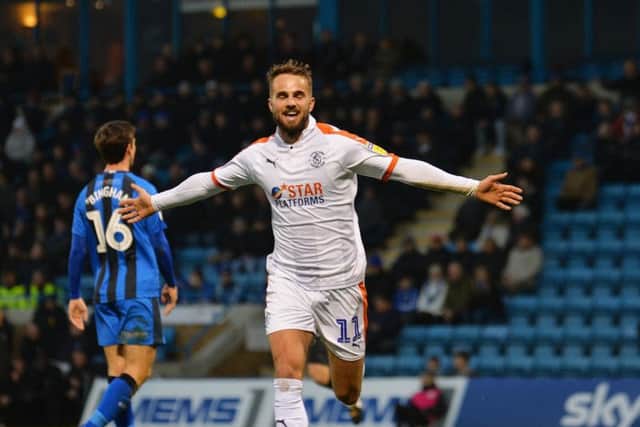 Andrew Shinnie wheels away after scoring at Gillingham