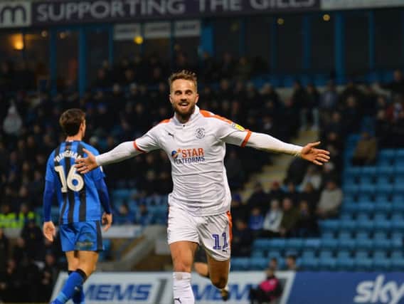 Andrew Shinnie wheels away after scoring at Gillingham
