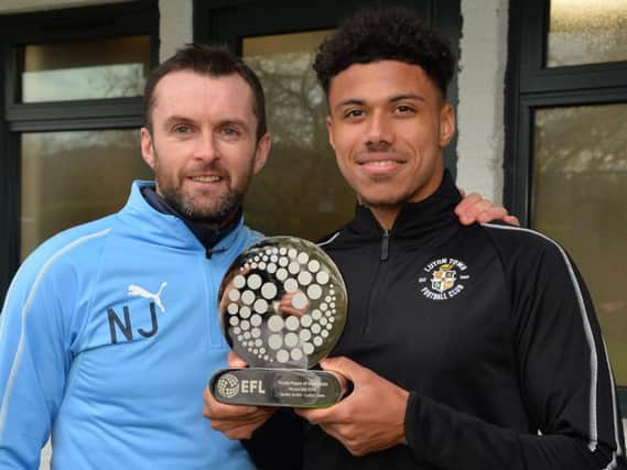 Hatters defender James Justin with his award and Luton chief Nathan Jones