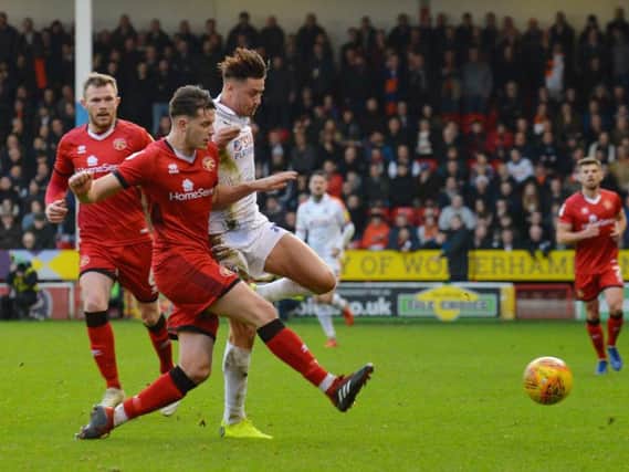 Harry Cornick is challenged during yesterday's 2-2 draw with Walsall