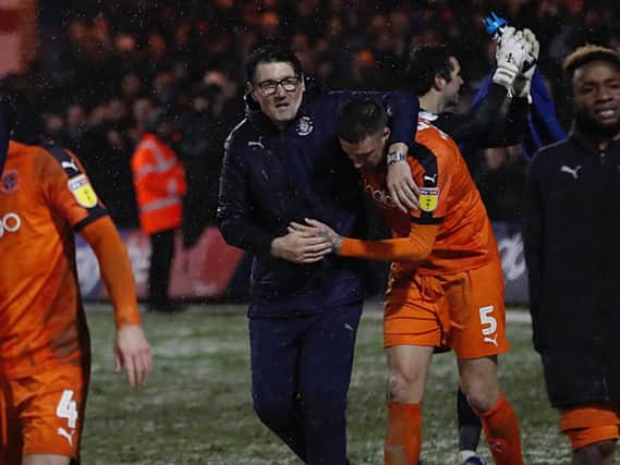 Mick Harford celebrates Town's win over Portsmouth with captain Sonny Bradley
