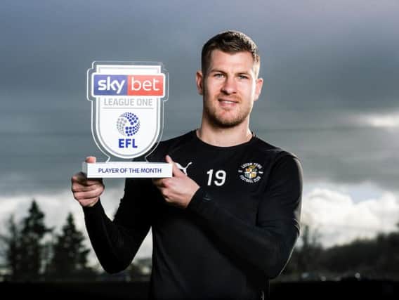Hatters striker James Collins with his League One award
