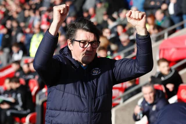 Hatters boss Mick Harford applauds the visiting fans at Fleetwood