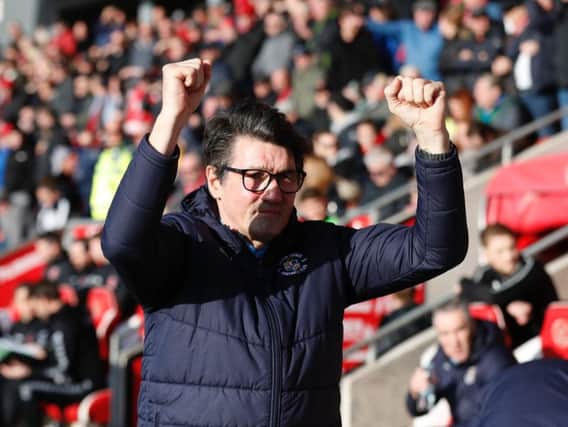 Hatters boss Mick Harford applauds the visiting fans at Fleetwood