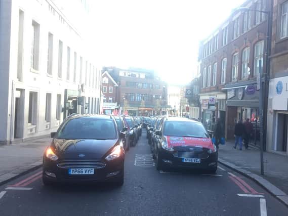 Minicab drivers are going slow in protest of the conditions working for Addison Lee. They have been going slow from the Luton Airport roundabout to George Street, they are now protesting outside the Town Hall, calling for the council to enforce legal workers rights for drivers