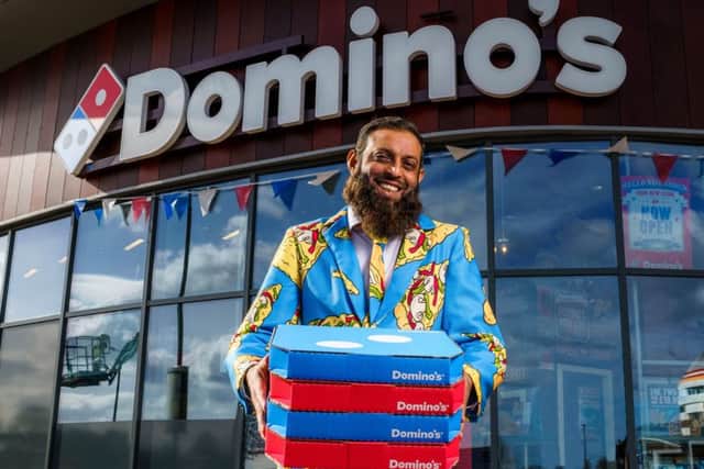 Pizza tycoon Arshad Yasin opens Dominos 1,100th store in a special 3-pizza suit.