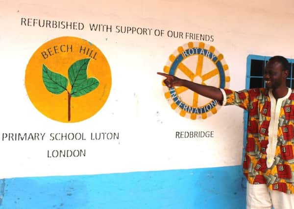 Lamin Saidy points to the Beech Hill twinning sign.