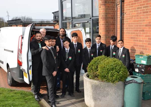 Pupils from CHSB with Amar Azam of the Luton Foodbank, and Aabid Khan, the lead teacher who worked with the boys on the project.