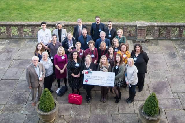 Representatives of the 17 selected charities receive a cheque at a celebratory closing event