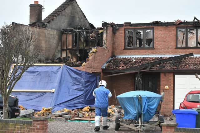 An investigator at the scene after a house fire in Peartree Road, Kirton, near Boston, in Lincolnshire, where police have launched a domestic-related murder investigation after three people were found dead after the New Year's Day fire. PRESS ASSOCIATION Photo. Picture date: Wednesday January 2, 2019. See PA story FIRE House. Photo credit should read: Joe Giddens/PA Wire EMN-190301-104039001