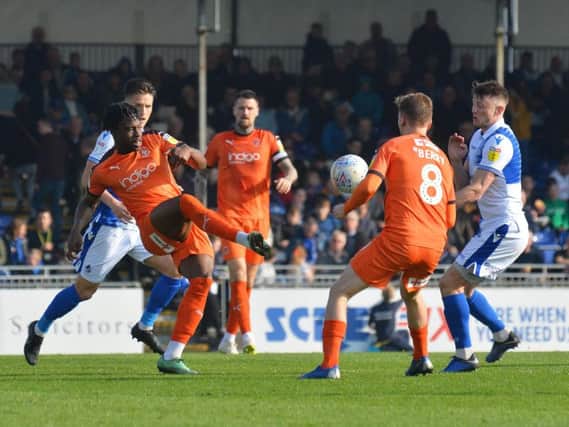 Pelly-Ruddock Mpanzu makes a pass against Bristol Rovers during his 200th game on Saturday