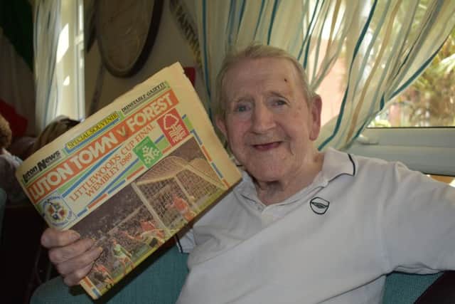Michael with an old newspaper copy gifted to the care home by LTFC by supporters liaison officer John Miller.