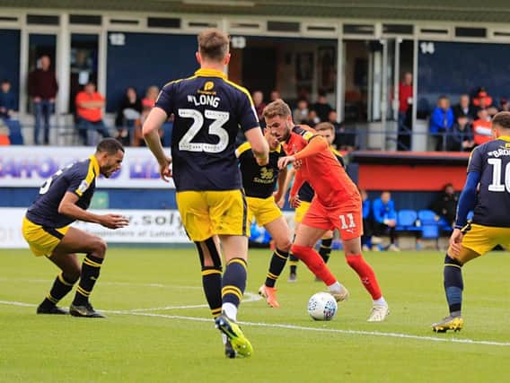 Midfielder Andrew Shinnie has extended his deal with Luton