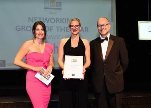 L-R Becky Ives (MC) Kate Cherry (The Athena Network) and Paul Adams (Bedford Borough Council) on stage at the SME Luton & Bedfordshire Business Awards 2019, the Bedford Corn Exchange, Bedford.