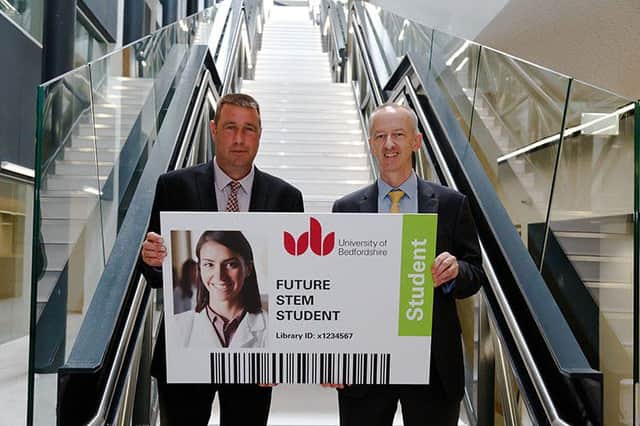 Douglas Stephen, project manager for R G Carter hands over the key card to Donald Harley, deputy vice-chancellor of the University of Bedfordshire