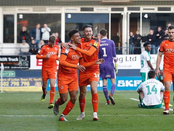 James Justin celebrates scoring for the Hatters