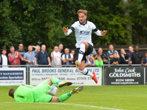 Andrew Shinnie hurdles Bedford Town keeper Alex Bennion this afternoon