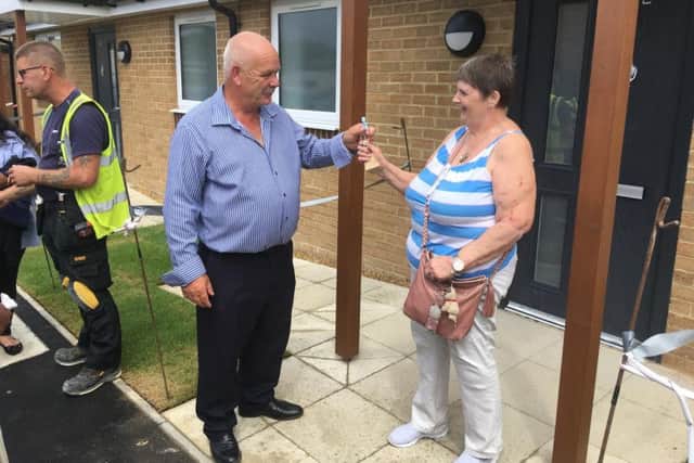 Councillor Tom Shaw handing the keys to first Roman Way resident Shirley Long