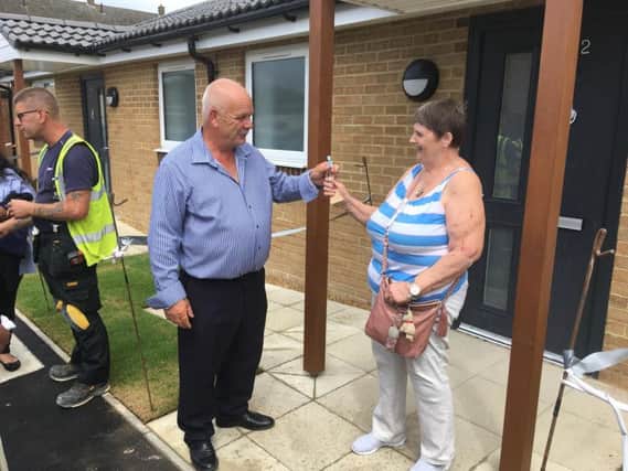 Councillor Tom Shaw handing the keys to first Roman Way resident Shirley Long