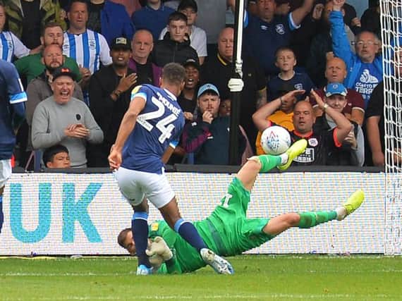 Simon Sluga saves from Huddersfield striker Steve Mounie on Saturday