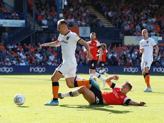 Luke Bolton slides in during yesterday's 3-0 defeat to Hull City
