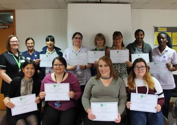 Some of the workers with their certificates