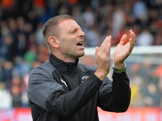 Town chief Graeme Jones applauds the home supporters