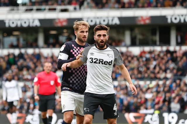 Andrew Shinnie marks his brother Graeme at Pride Park