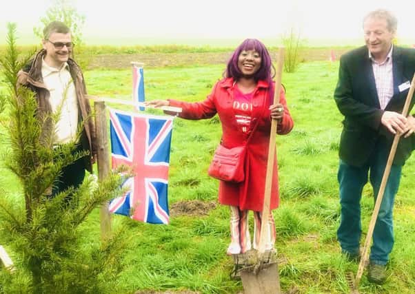 Mary (middle) planting a Yew tree with Swiss arts director Ulrich Suter (left) and artist Wetz (right).