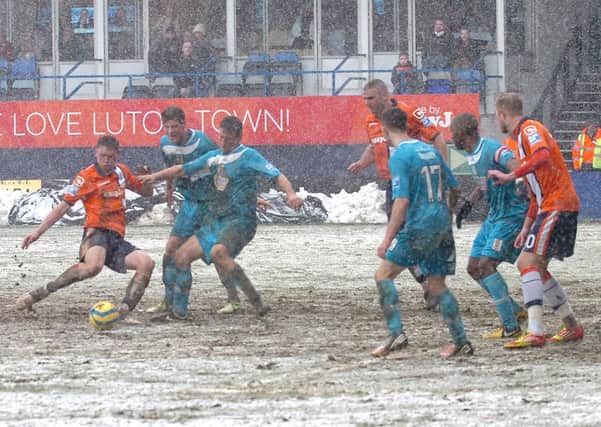 Jake Goodman in the thick of the action at a snowy Kenilworth Road on Saturday
