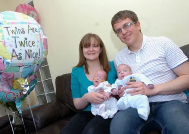 Kayleigh and Thom Darby with their tiny twins Caitlin (left) and Daniel