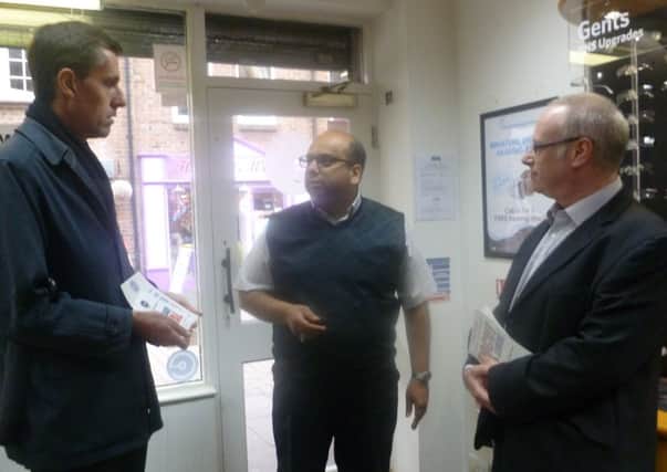 Andrew Selous MP (left) talks to Dunstable businessman Aktar Jaffer (centre) as Damian Cummins of the Federation of Small Businesses (right) looks on