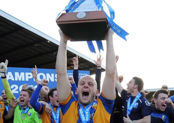 Mansfield Town captain Adam Murray lifts the Blue Square Premier League trophy.