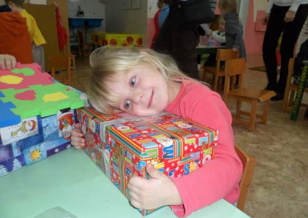 Four-year-old Victoria from Belarus can't believe this shoebox is all hers